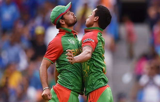 Bangladeshs Taskin Ahmed, right, celebrates with his teammate Mashrafe Mortaza after taking the wicket of India's Ajinkya Rahane during their Cricket World Cup quarterfinal match in Melbourne, Australia, Thursday, March 19, 2015. (AP Photo/Andy Brownbill)