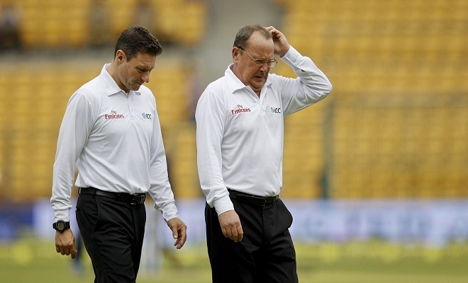 Umpire Ian Gould, right, gestures after inspecting the pitch and outfield with colleague Richard Allan Kettleborough, left, before calling off play for the fourth day of second cricket test match between India and South Africa due to rains in Bangalore, India, Tuesday, Nov. 17, 2015. The second test between India and South Africa looked set for a draw Tuesday after no play was possible on the fourth day. (AP Photo/Aijaz Rahi)