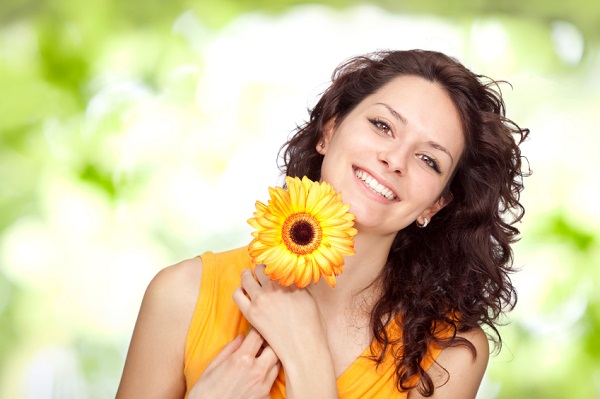 beautiful orange young brunette girl expression portrait with daisy flower