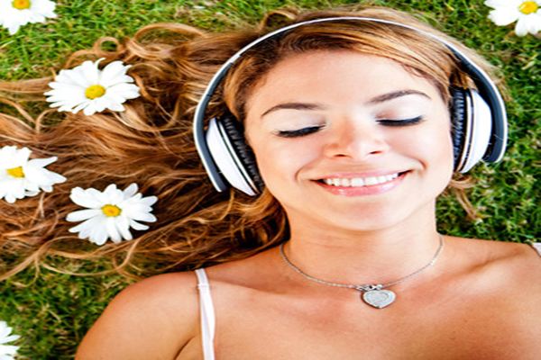 Woman listening to music with headphones outdoors