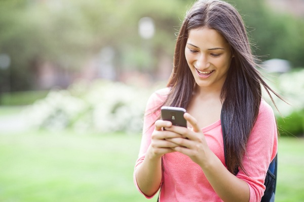 teen girl texting with smartphone