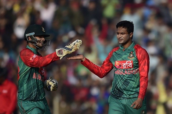 Bangladesh cricketer Shakib Al Hasan (R) celebrates with his teammate Nurul Hasan (L) after the dismissal of the Zimbabwe cricketer Vusi Sibanda during the first T20 cricket match between Bangladesh and Zimbabwe at the Sheikh Abu Naser Stadium in Khulna on January 16, 2016.  AFP PHOTO/ Munir uz ZAMAN / AFP / MUNIR UZ ZAMAN        (Photo credit should read MUNIR UZ ZAMAN/AFP/Getty Images)