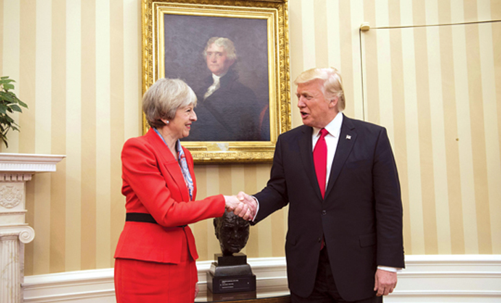 British Prime Minister Theresa May (L) and US President Donald Trump meet beside a bust of former British Prime Minister Winston Churchill in the Oval Office of the White House on January 27, 2017 in Washington, DC. / AFP PHOTO / Brendan Smialowski