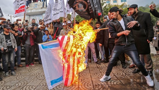 Palestinian protesters burn the U.S. and Israeli flags in Gaza City on Wednesday. President Trump is set to recognize Jerusalem as Israel's capital, upending decades of U.S. policy and ignoring dire warnings from allies.